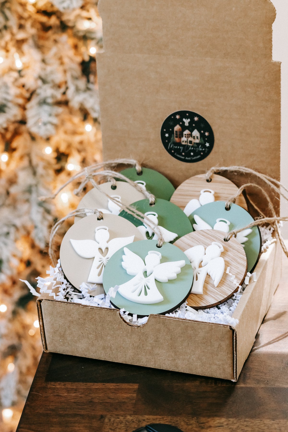 Layered angel ornament set in kraft box, round green and wood discs with twine hangers