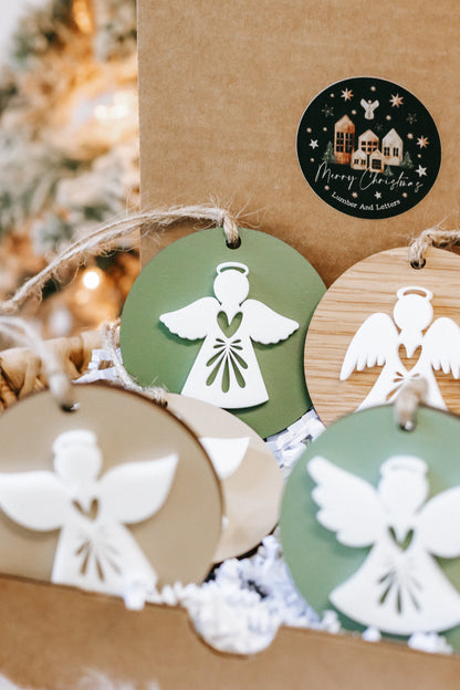 Angel ornament pair in green and wood, white winged figures with twine loops