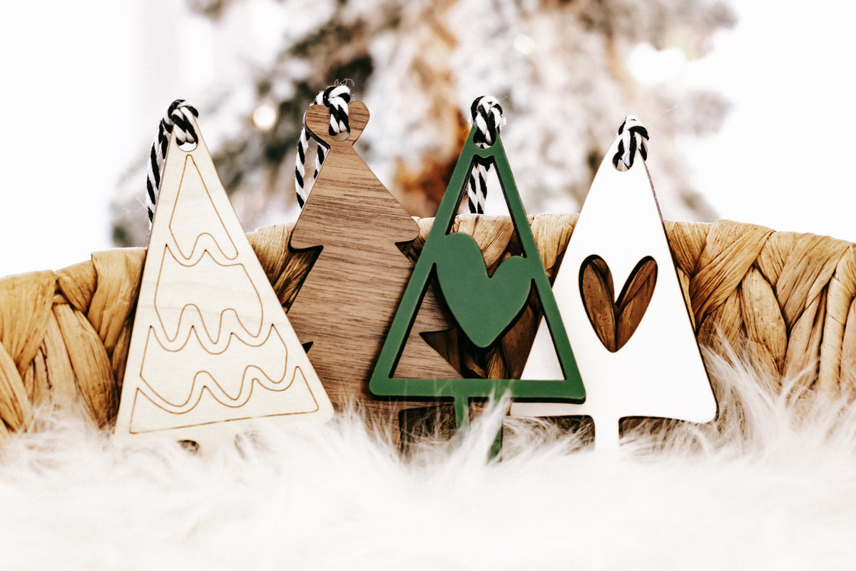 Assorted wooden Christmas tree and heart ornaments with green and natural finishes, rope hangers