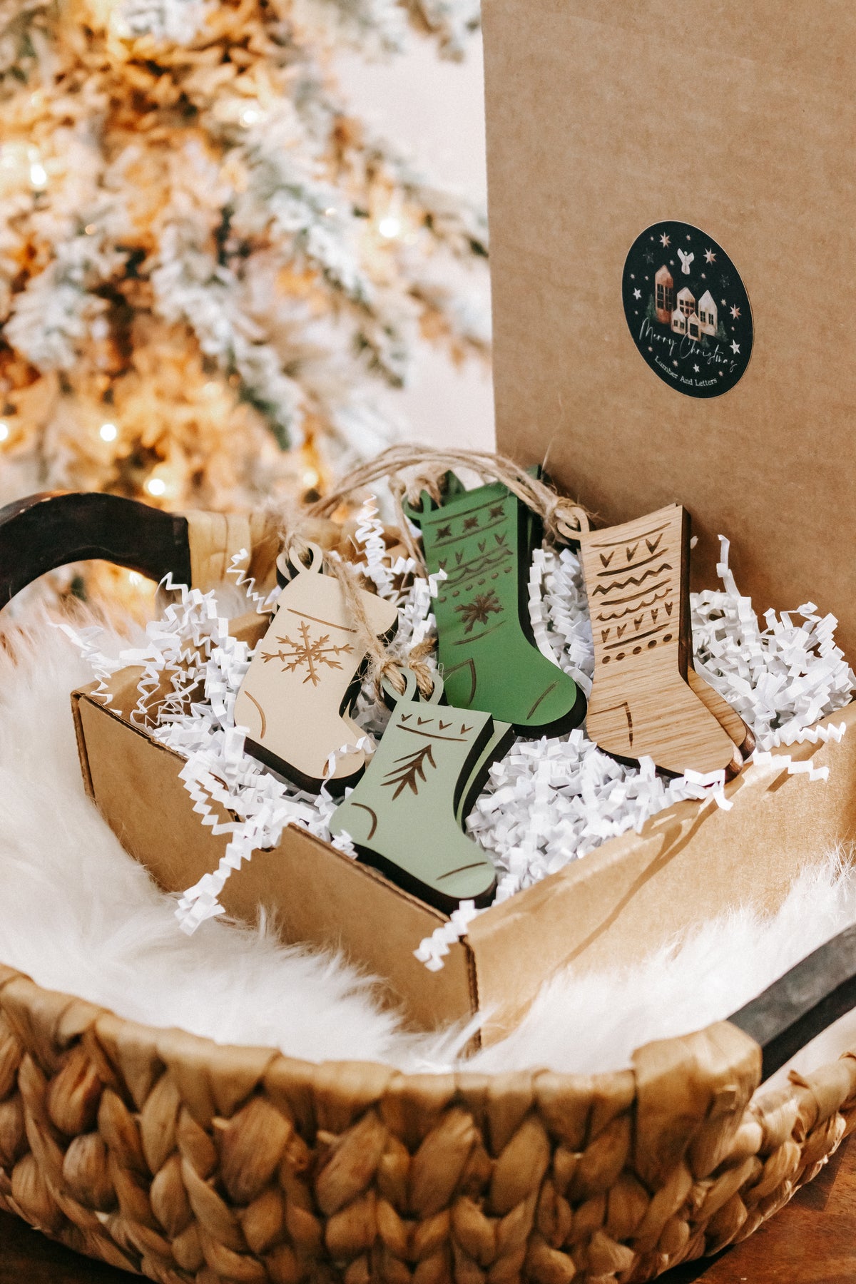 Wood stocking ornaments with engraved icons, in a kraft box filled with white shredded paper