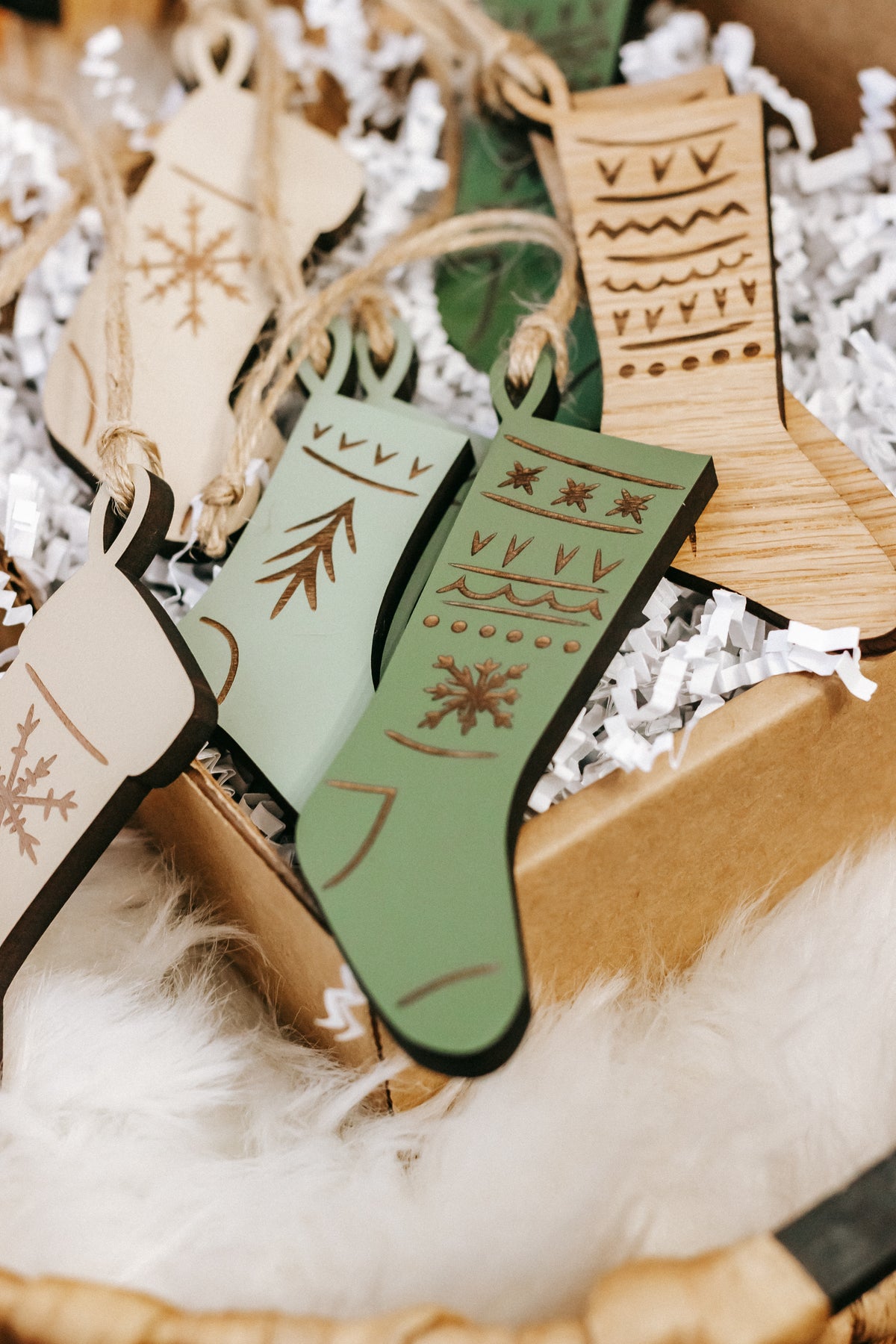 Cluster of engraved wooden stocking ornaments with carved tree and snowflake motifs