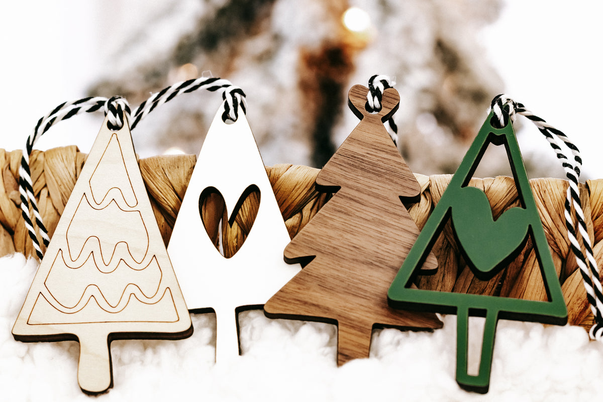 Mix of wooden Christmas ornaments in green and natural finishes with stripe rope hangers
