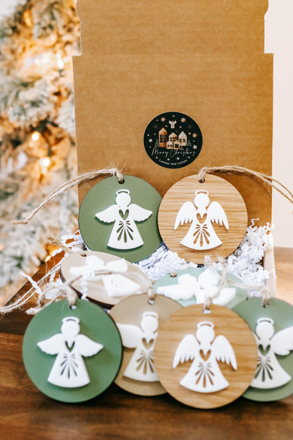 Grouped layered angel ornaments on twine, green and wood round tags with cutout angels