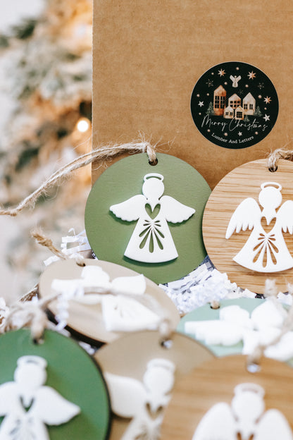 Layered angel ornament discs on twine, featuring green angel and white angel designs