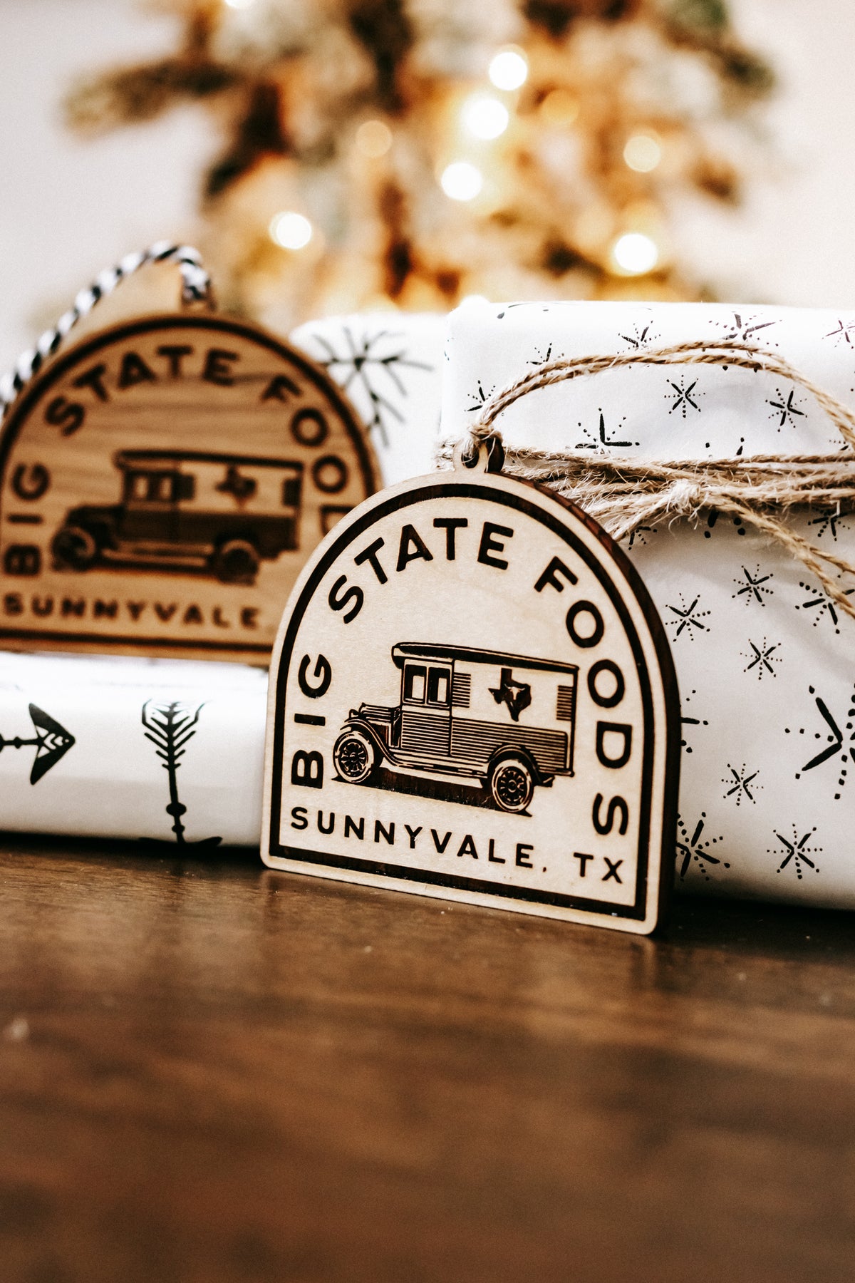 Wood state logo ornament with hanging twine and engraved bus graphic