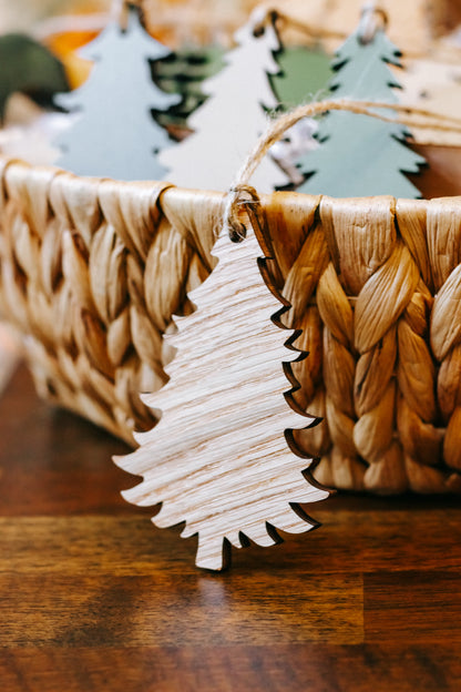 Close-up of wooden Christmas tree ornament with twine loop on woven basket