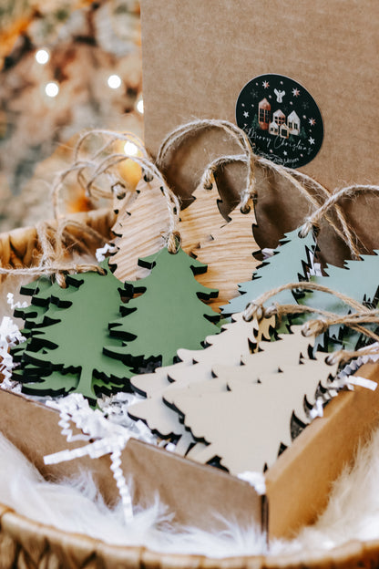Wooden Christmas tree ornaments in green and natural wood with twine hangers in basket