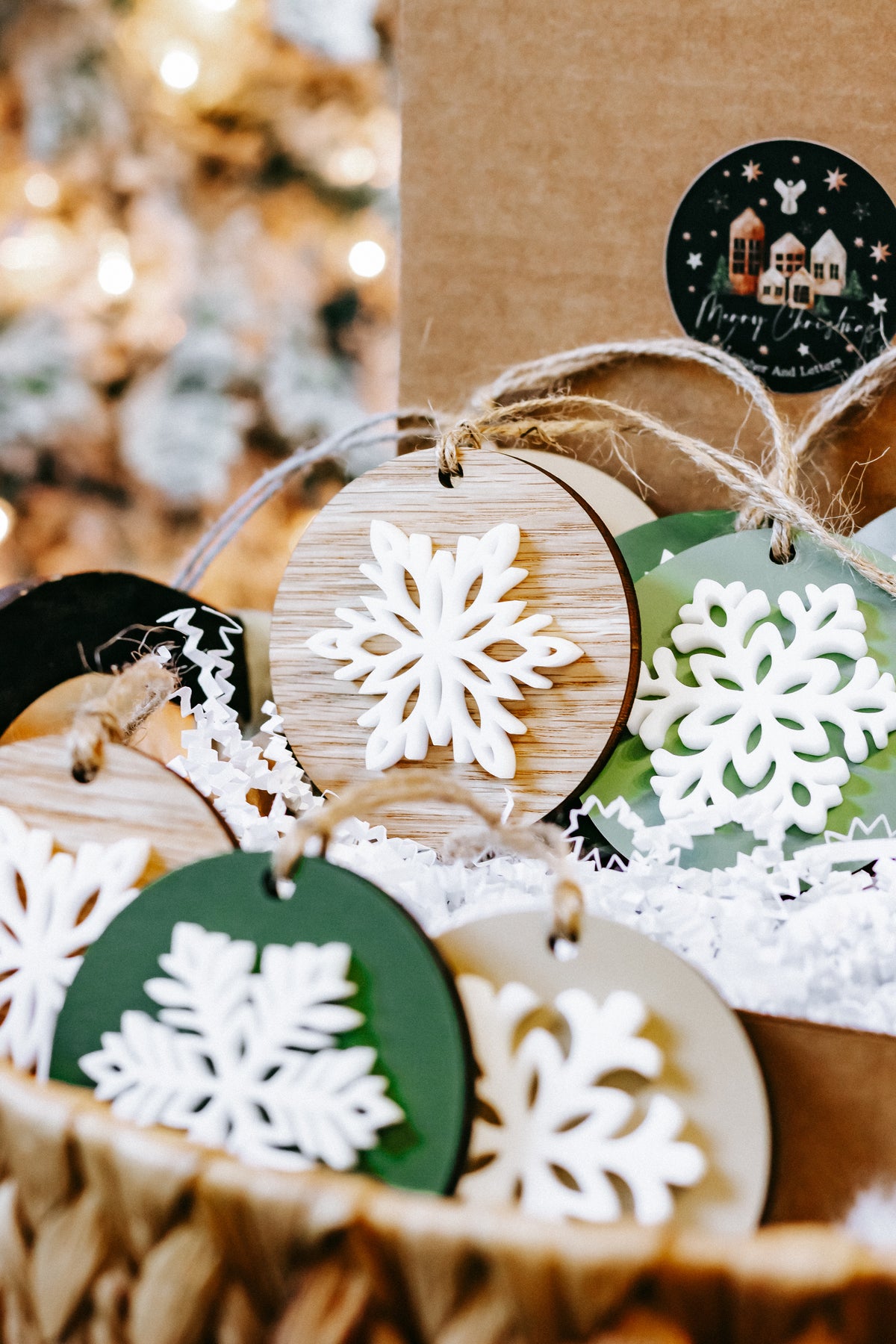 Cluster of round wooden snowflake ornaments with green and wood discs, white snowflake cutouts