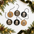Round wooden house ornaments with cutout windows, hanging on striped twine cords