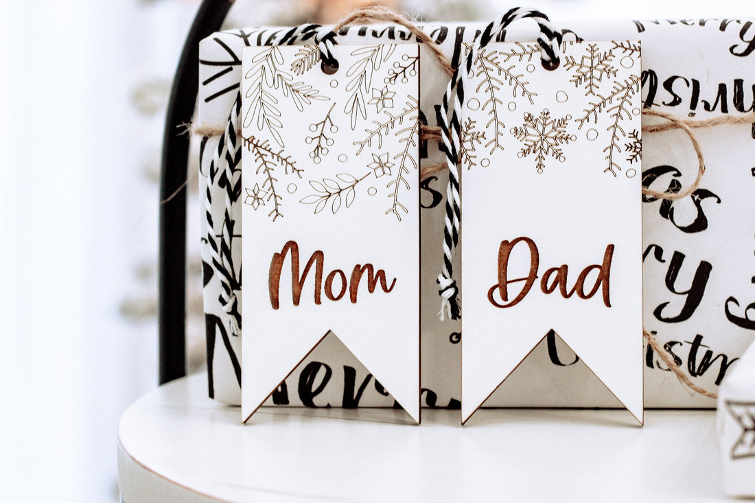 Boho floral stocking name tags on a white display, with Mom and Dad text
