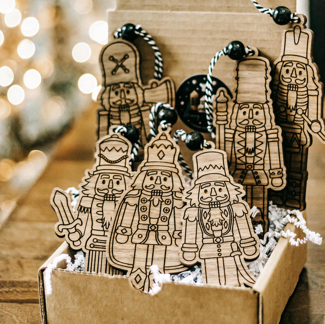 Set of 6 engraved wooden nutcracker ornaments in a gift box with dark bead hangers