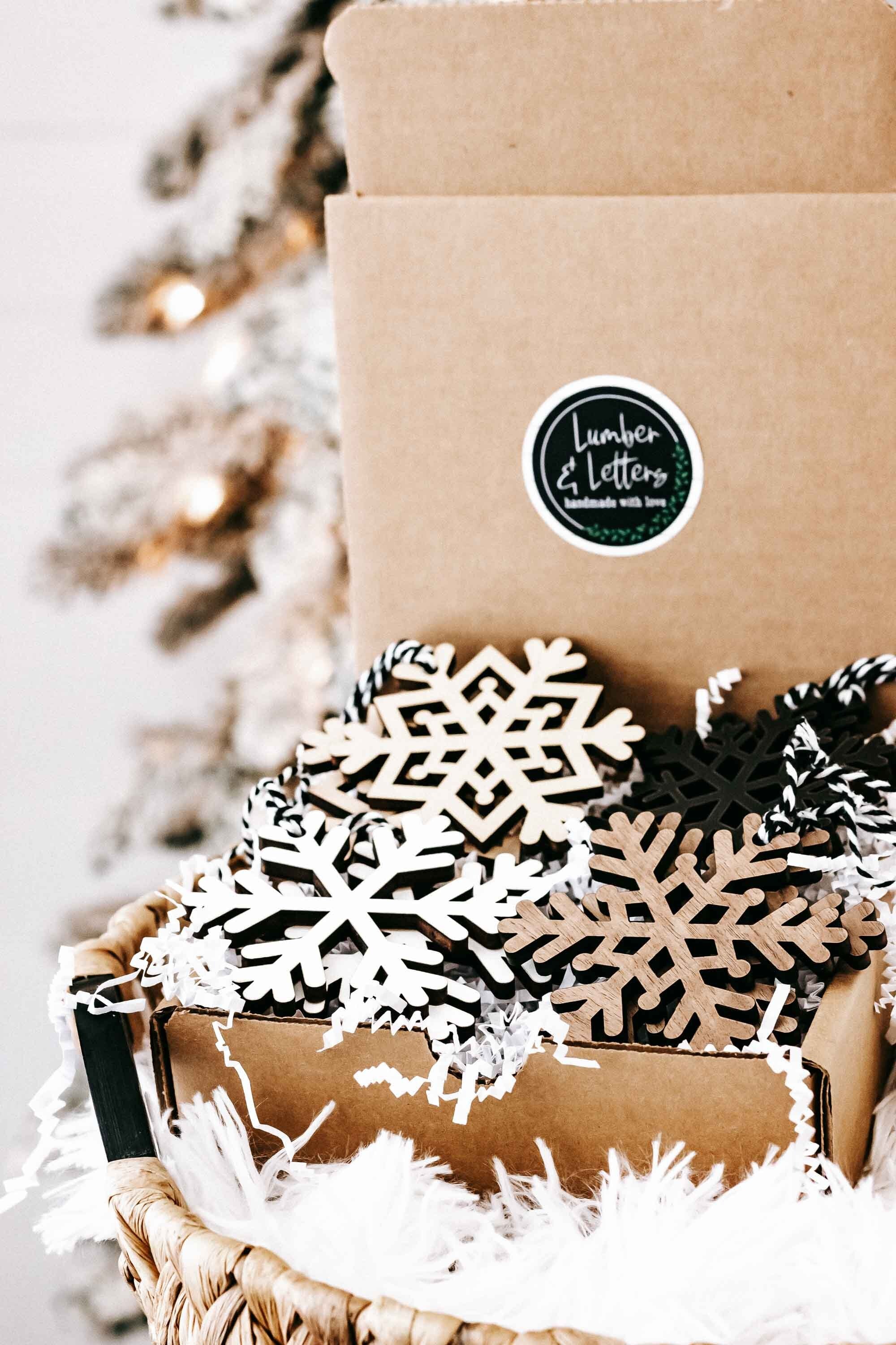 Wood snowflake ornament set in a gift box: white lattice, dark snowflakes, braided hangers