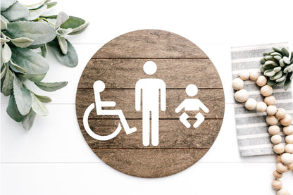 Round wood accessibility sign with male, wheelchair, and changing icons