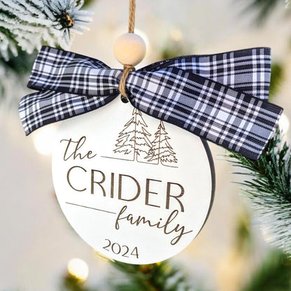Family name Christmas ornament with navy and white plaid bow, “The CRIDER family 2024”