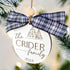 Family name Christmas ornament with navy and white plaid bow, “The CRIDER family 2024”