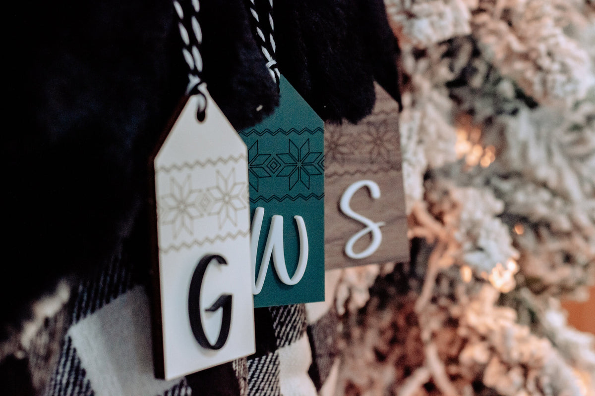 Personalized stocking tags with letters G, W, and S in patterned wood and teal