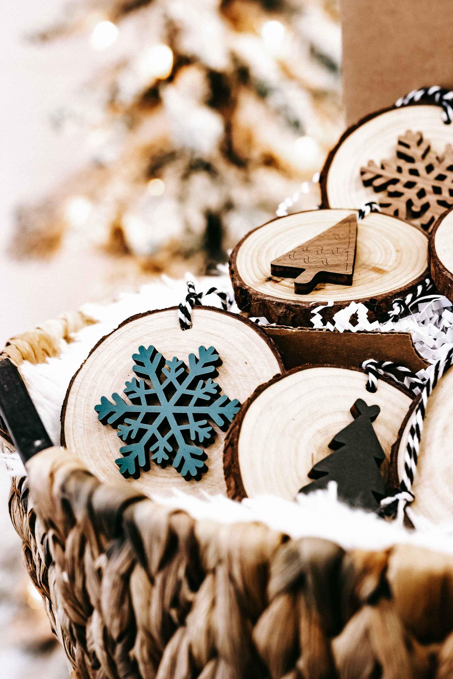 Wood slice Christmas ornaments with snowflake and small tree motifs, string hangers