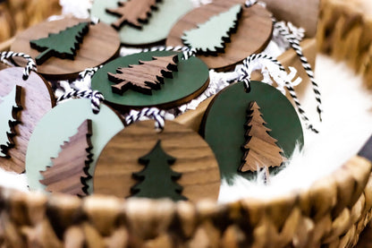 Close view of wooden Christmas tree ornaments with painted green details and striped cords