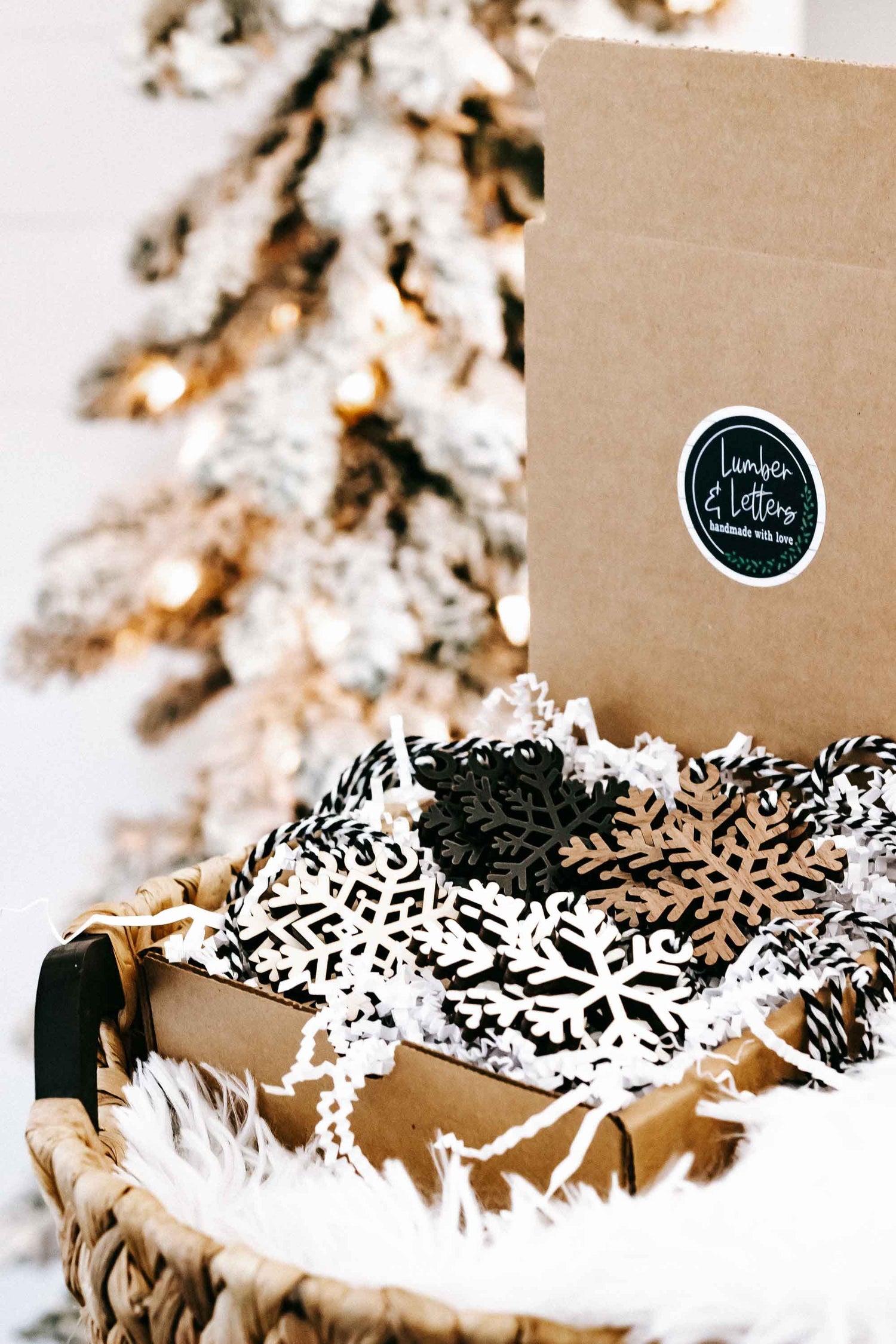 Snowflake wooden ornaments in a kraft gift box, black and beige with white cutout accents