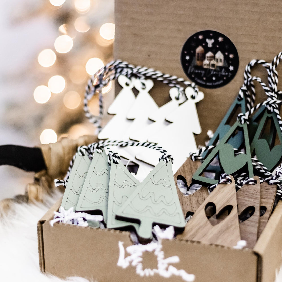 Set of wooden Christmas tree ornaments in kraft box with striped hanging strings