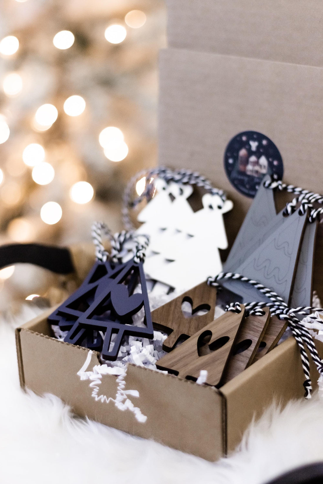 Set of 16 wooden Christmas tree ornaments in navy and gray with white hanging strings