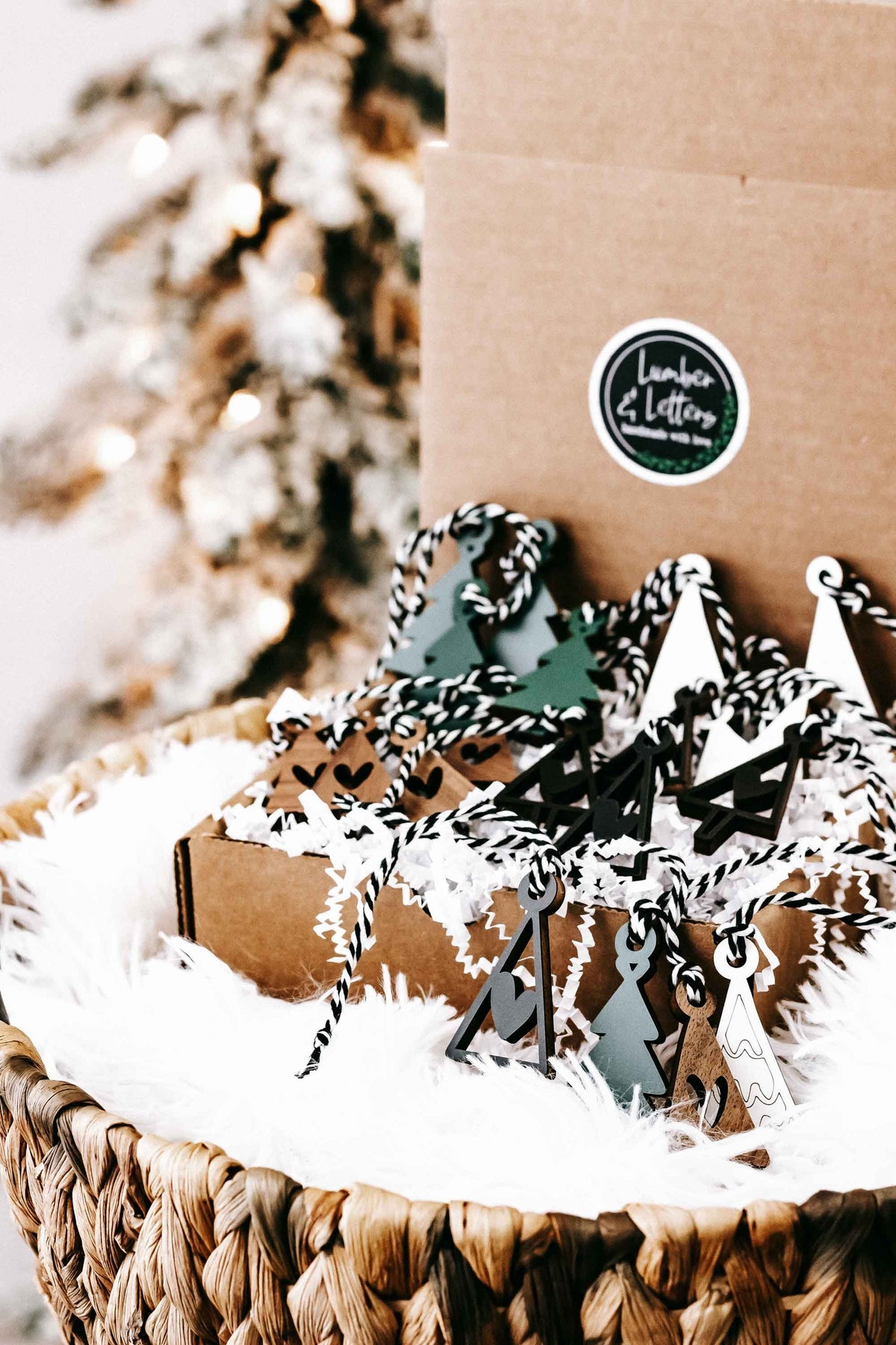 Set of mini wooden tree ornaments with hanging loops and faux-snow presentation