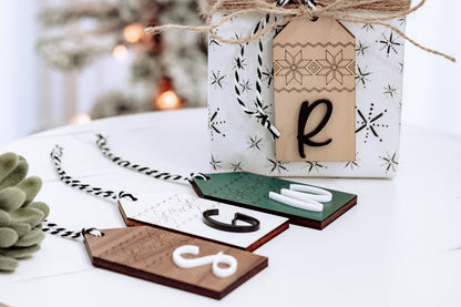 Personalized wood stocking tag with Nordic pattern and letter R, tied with twine