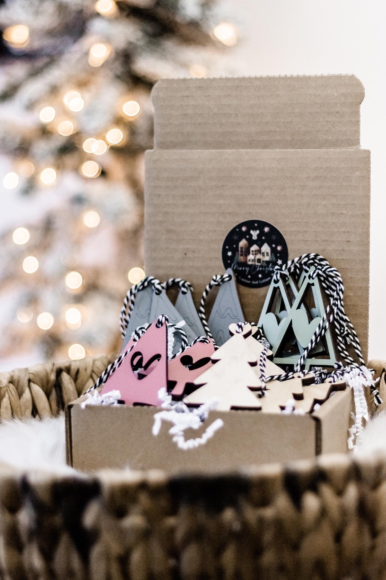Boho Christmas ornaments in kraft box with hanging trees in gray, blush pink, and sage tones
