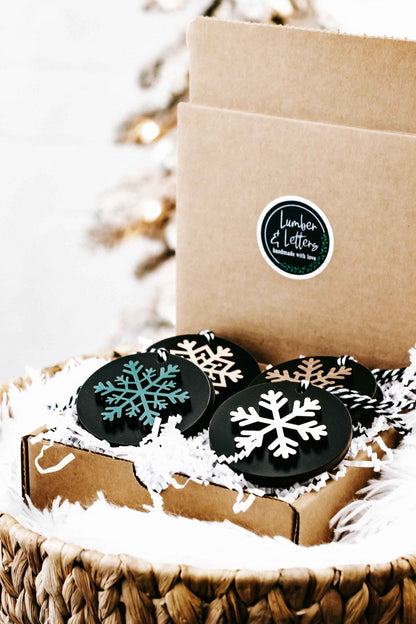 Set of 8 black wooden snowflake ornaments in kraft box on straw basket with white fur