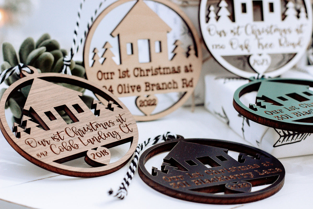 Multiple round wooden Christmas keepsake ornaments with laser-cut designs and hanging loops