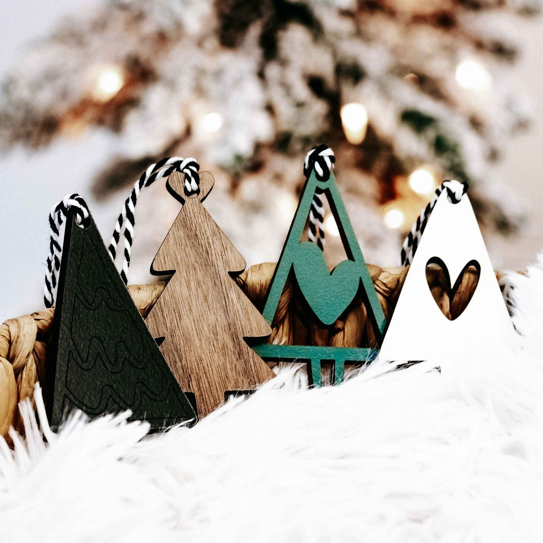 Set of wooden Christmas tree ornaments in natural wood and dark green, with striped rope hangers