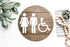 Round 3D restroom accessibility sign with white male, female, and wheelchair icons