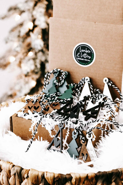 Mini wooden Christmas tree ornaments with hanging loops, cutout tree shapes in mixed colors