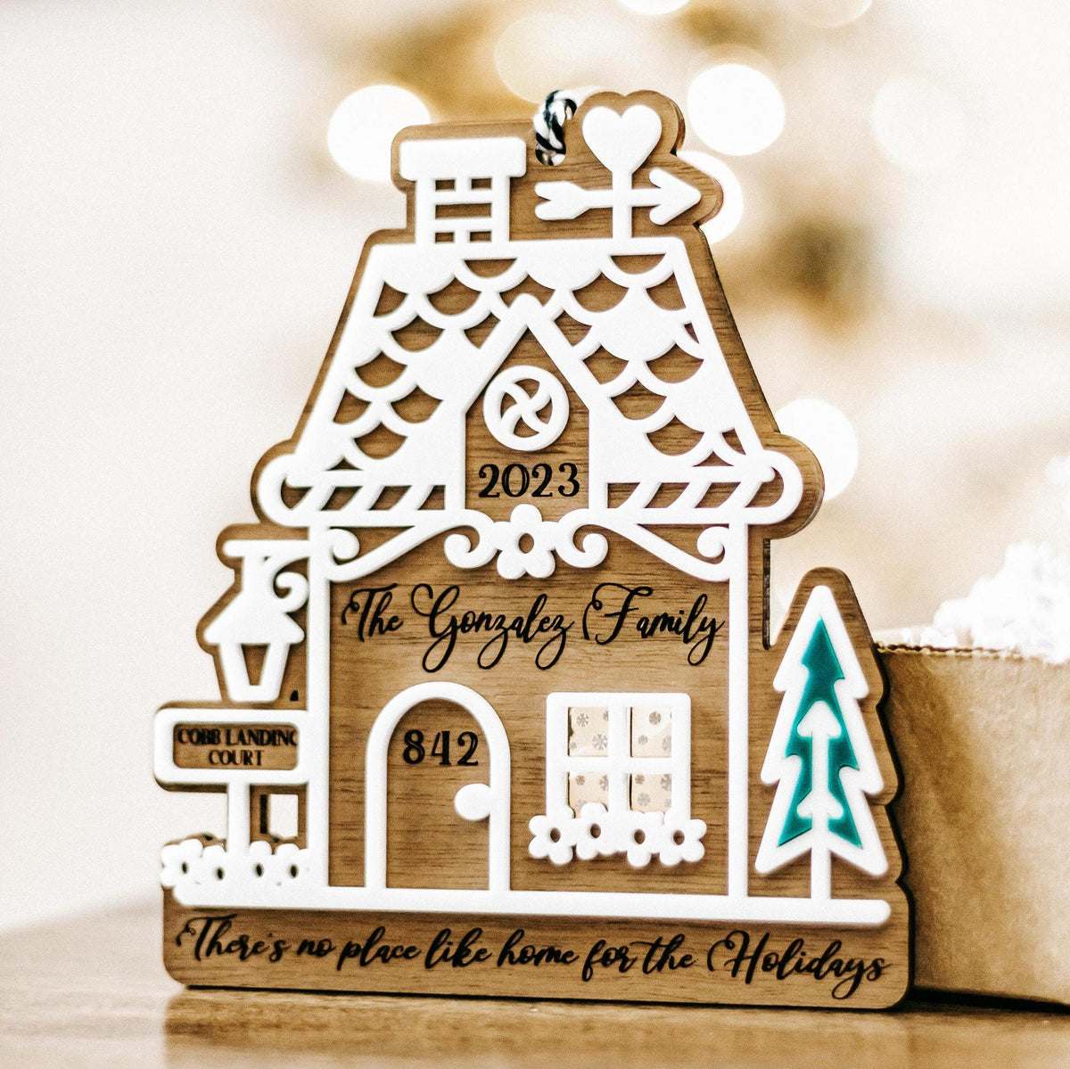 Wood gingerbread house ornament with “2023” and “Gonzalez Family,” teal tree cutout
