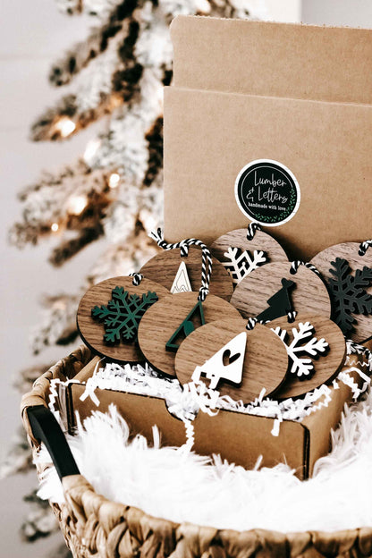 Wooden Christmas ornament set with snowflake and tree shapes, striped string hangers