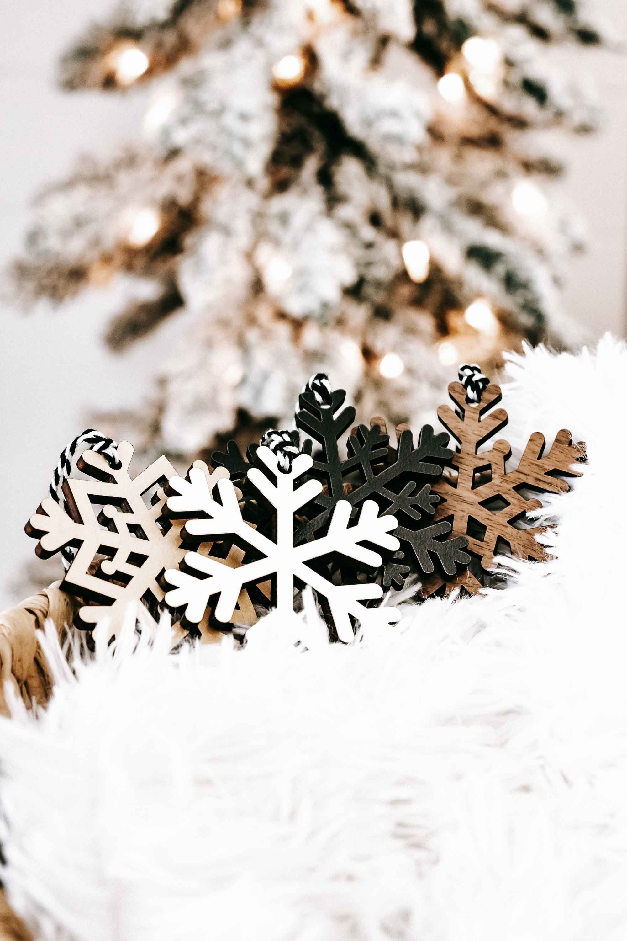 Wood snowflake ornaments set: white, dark, and tan snowflake cutouts with small top loops