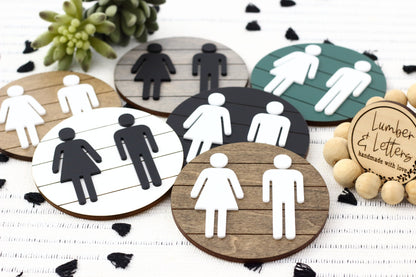 Assorted round 3D restroom accessibility signs with male, female, and wheelchair icons