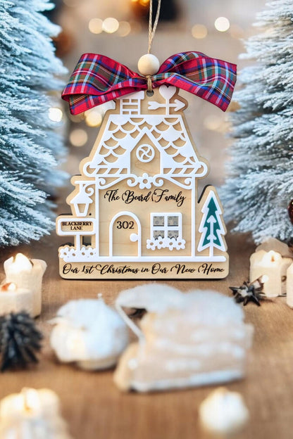 Wood gingerbread house ornament with red plaid bow, “302,” “Bond Family,” and teal tree