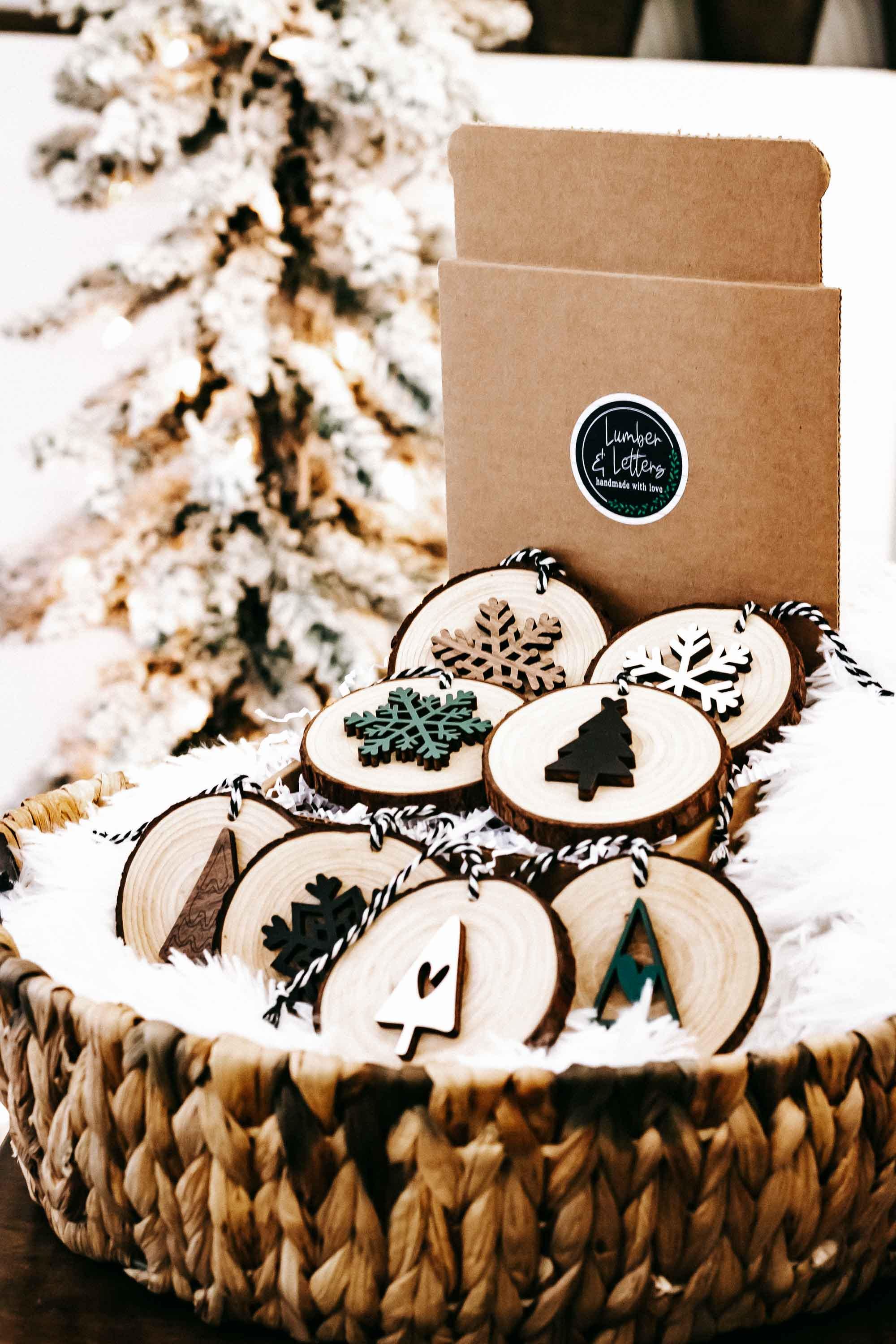 Wood slice Christmas ornament set of 8 with snowflakes and trees, in woven basket