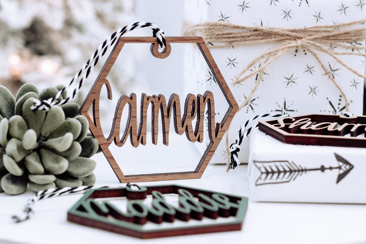 Wooden hex name ornament with cursive “Tammon” engraving, dark twine loop