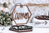 Wooden hex name ornament with cursive “Tammon” engraving, dark twine loop