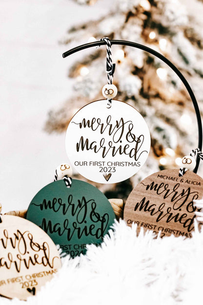Assorted round “Merry &amp; Married” Christmas ornaments on black arched hanger with year text