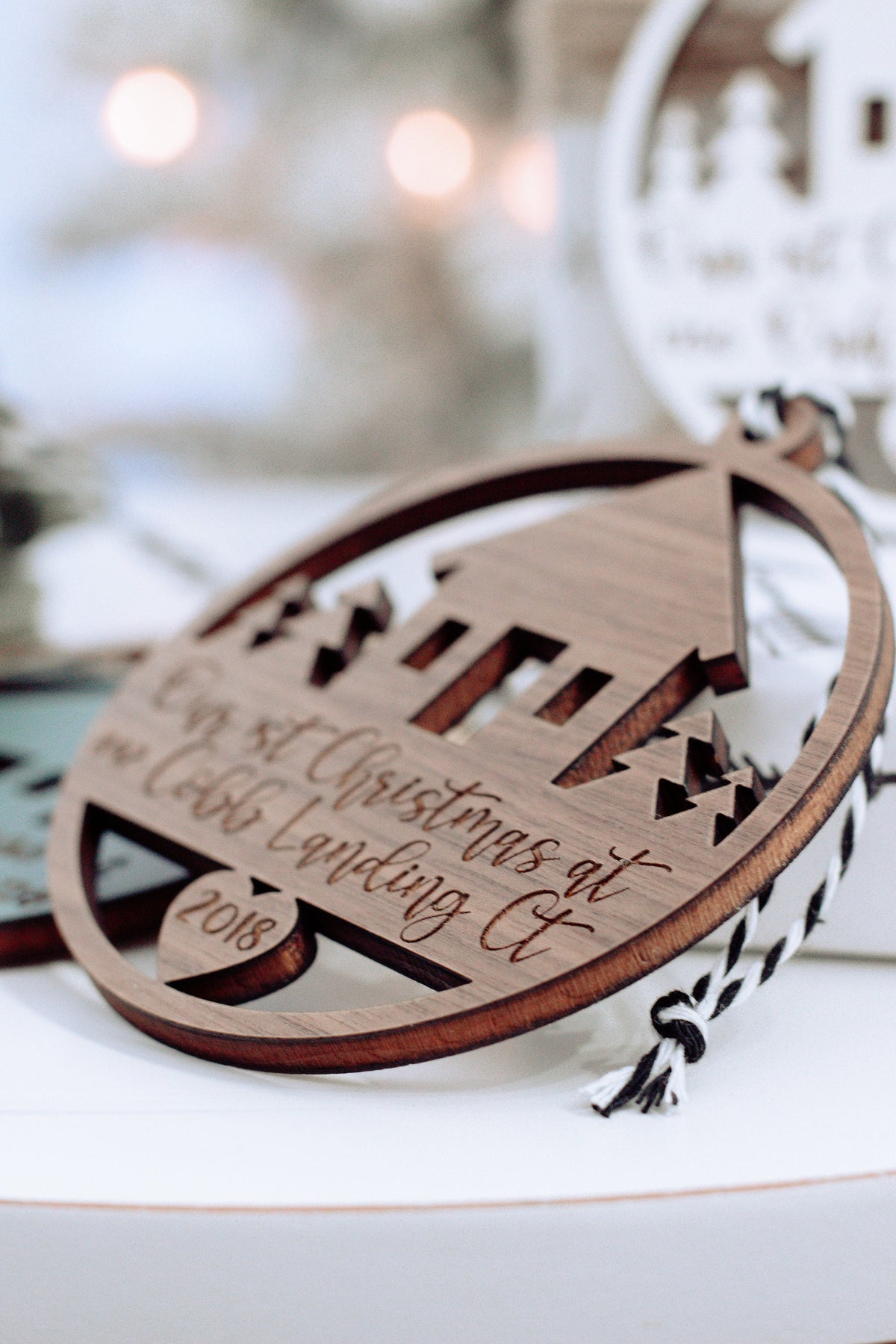 Oval wooden Christmas ornament with laser-cut arch design and hanging loop