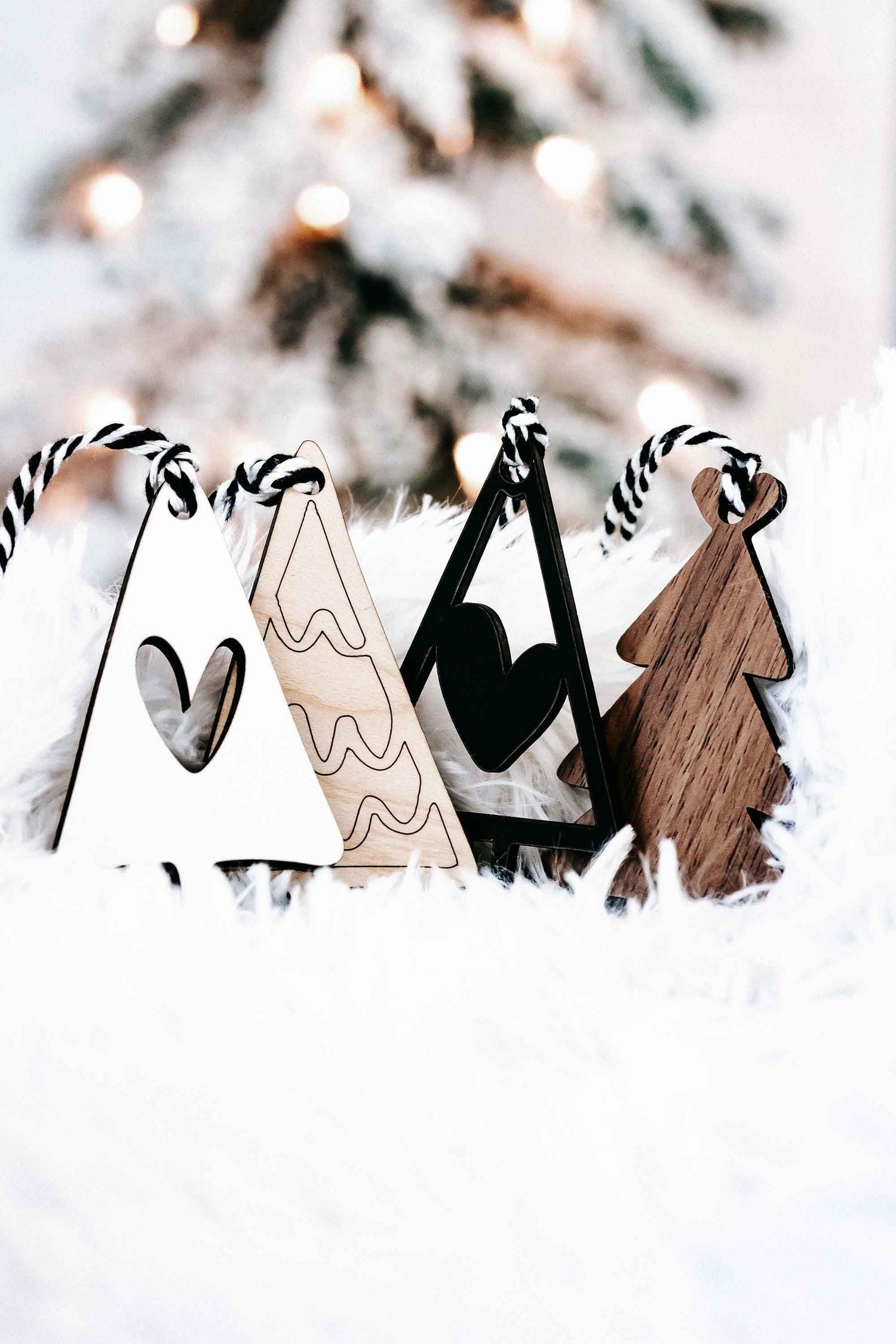 Boho Christmas tree ornaments set with striped rope hangers in wood, white, and black triangle trees