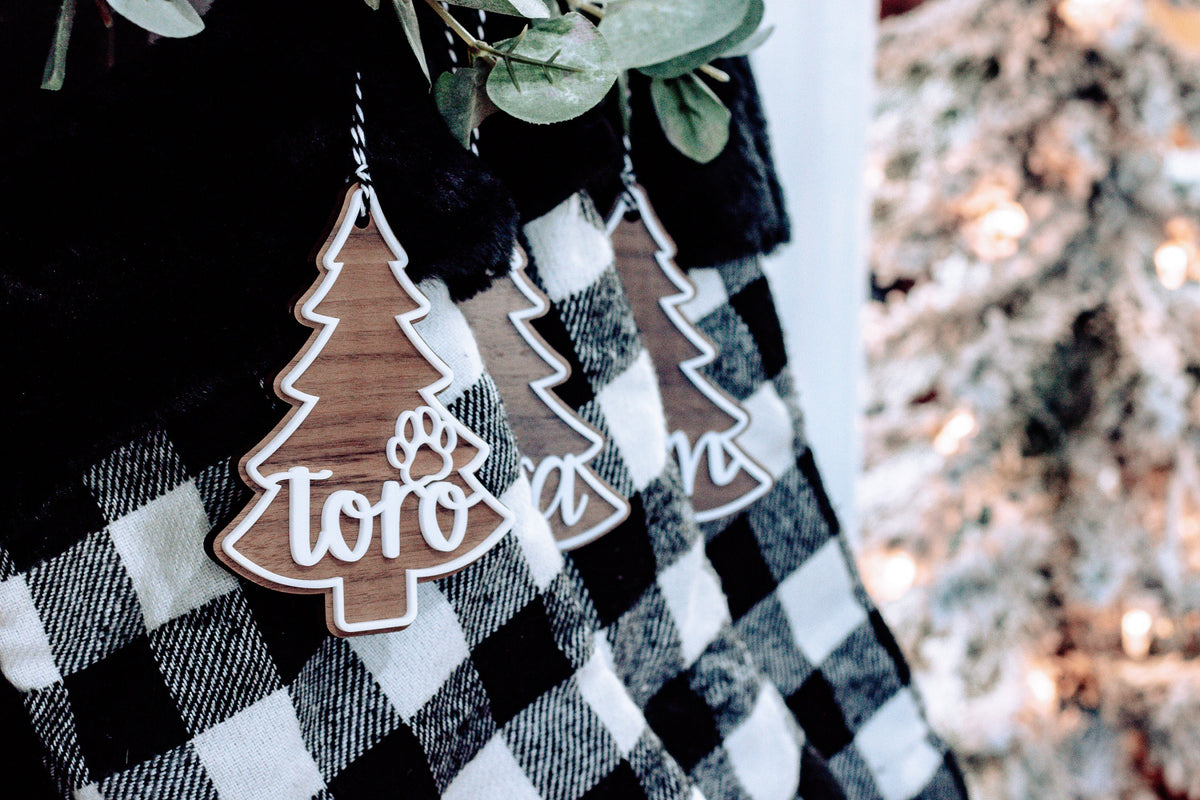 Christmas tree-shaped ornament tags with border design on buffalo plaid