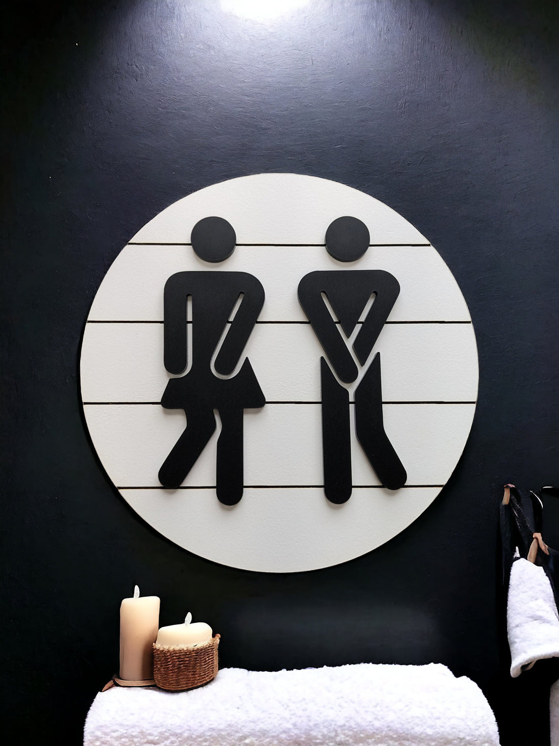 Circular restroom shiplap sign with raised male and female icons, black on white