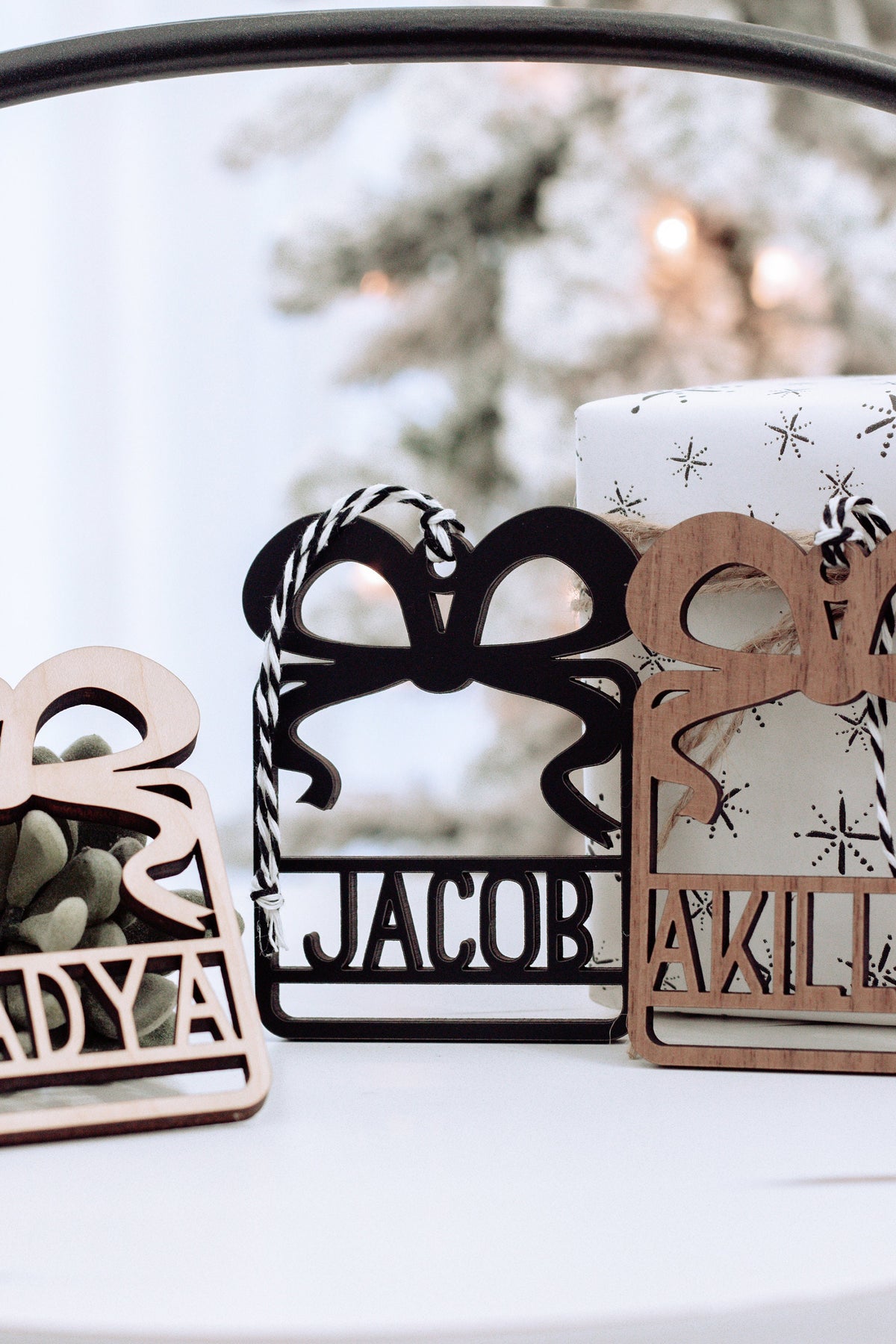 Wooden name ornaments in black and walnut tones with cut-out letters, gift box