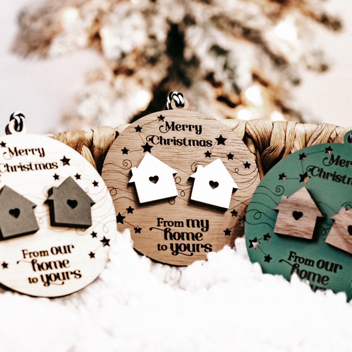 Set of round wooden Christmas ornaments in white, brown, and green with house cutouts