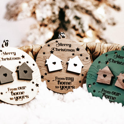 Set of round wooden Christmas ornaments in white, brown, and green with house cutouts