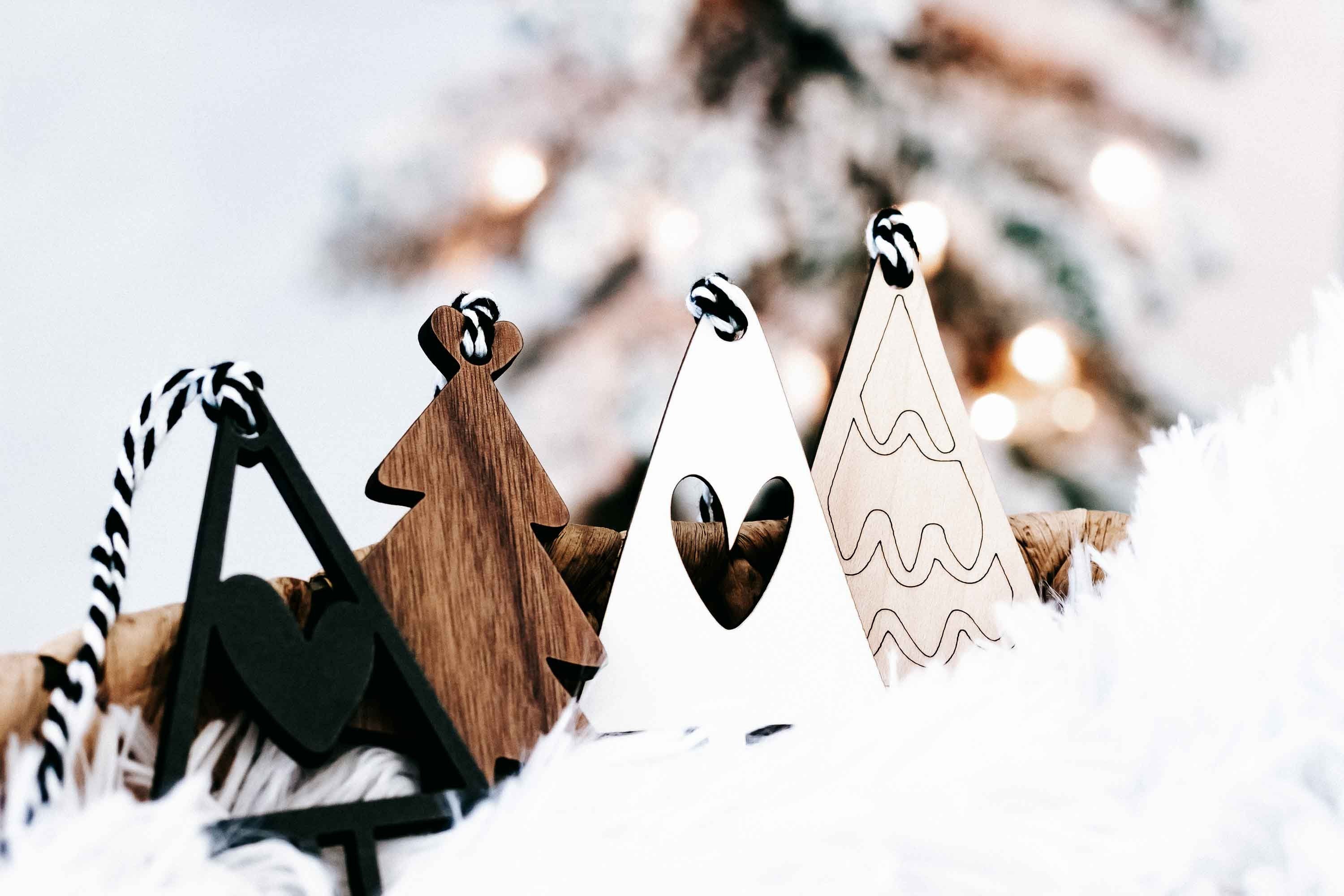 Boho Christmas tree ornaments showing wood, black, and white shapes with striped rope hangers